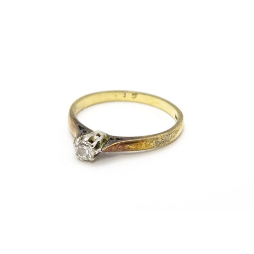 810 - A 9ct gold ring set with diamond solitaire. Ring size approx. L 1/2