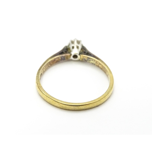 810 - A 9ct gold ring set with diamond solitaire. Ring size approx. L 1/2