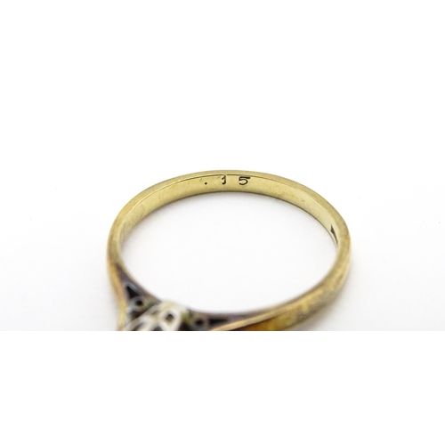 810 - A 9ct gold ring set with diamond solitaire. Ring size approx. L 1/2