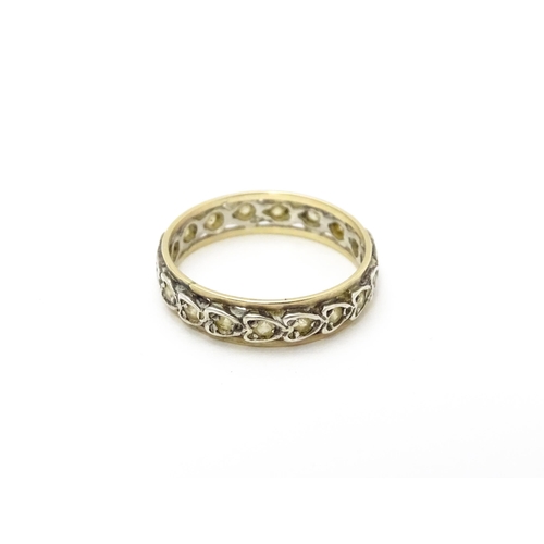 811 - A white and yellow metal ring set with white stones. Ring size approx. O