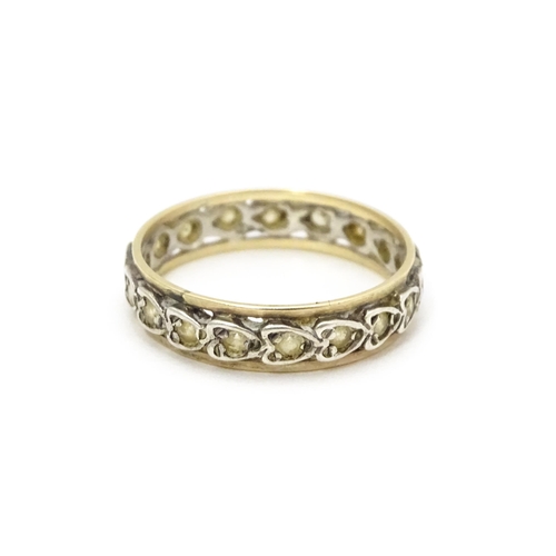 811 - A white and yellow metal ring set with white stones. Ring size approx. O