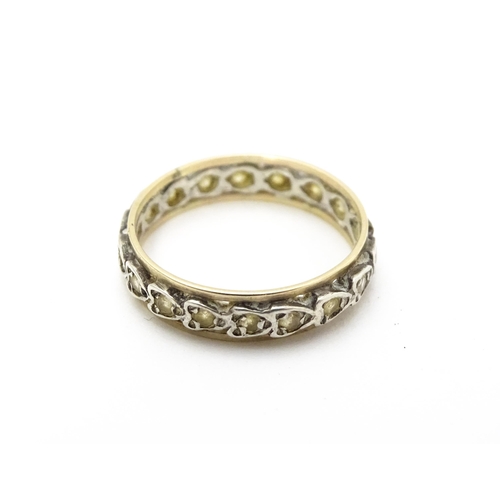 811 - A white and yellow metal ring set with white stones. Ring size approx. O