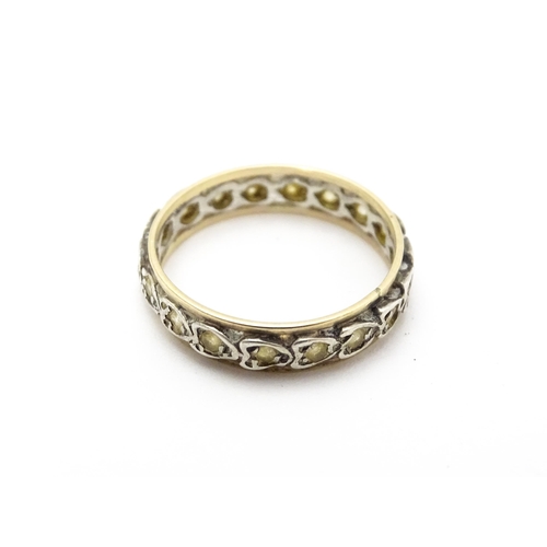 811 - A white and yellow metal ring set with white stones. Ring size approx. O