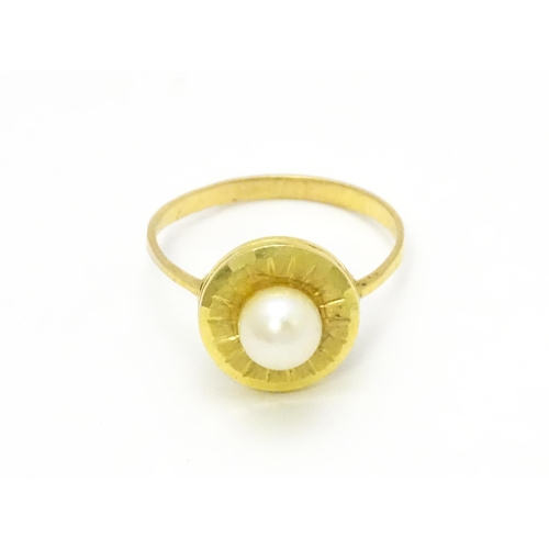 812 - A Continental 9ct gold ring set with central pearl. Ring size approx. L 1/2