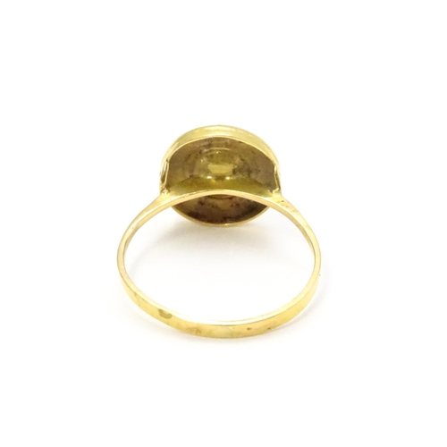 812 - A Continental 9ct gold ring set with central pearl. Ring size approx. L 1/2