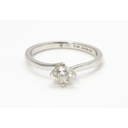 813 - A 18ct white gold ring set with diamond solitaire. Ring size approx. K 1/2