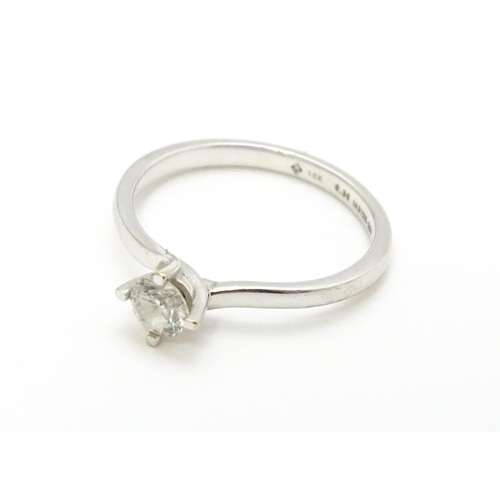 813 - A 18ct white gold ring set with diamond solitaire. Ring size approx. K 1/2