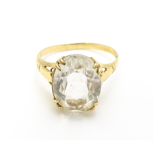 814 - A 9ct gold cocktail ring set with central white stone. Ring size approx. I 1/2