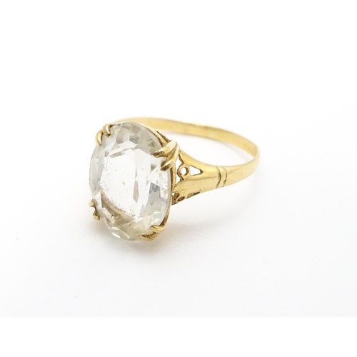 814 - A 9ct gold cocktail ring set with central white stone. Ring size approx. I 1/2