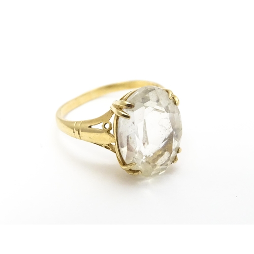 814 - A 9ct gold cocktail ring set with central white stone. Ring size approx. I 1/2