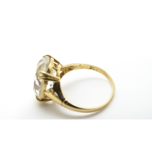 814 - A 9ct gold cocktail ring set with central white stone. Ring size approx. I 1/2