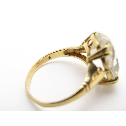 814 - A 9ct gold cocktail ring set with central white stone. Ring size approx. I 1/2