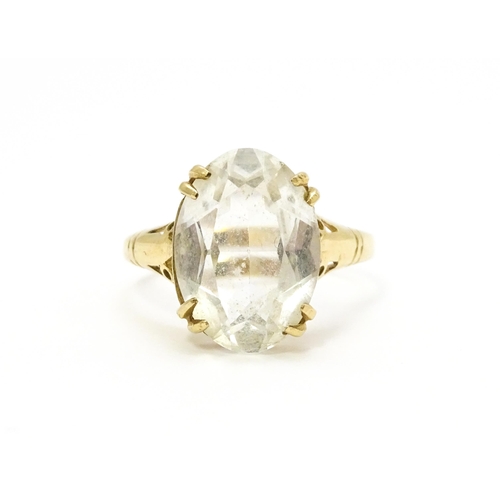 814 - A 9ct gold cocktail ring set with central white stone. Ring size approx. I 1/2