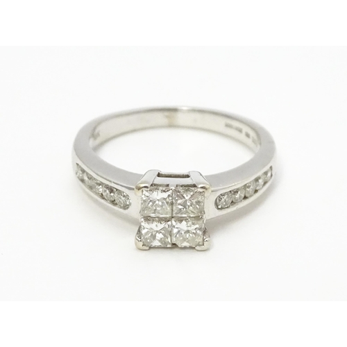 817 - An 18ct white gold ring set with four central diamonds flanked by five further diamonds to each shou... 