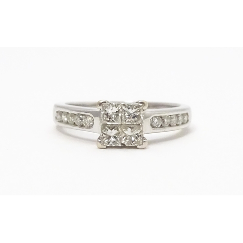 817 - An 18ct white gold ring set with four central diamonds flanked by five further diamonds to each shou... 