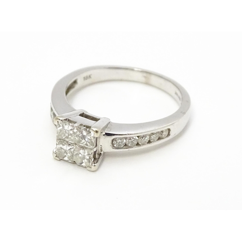 817 - An 18ct white gold ring set with four central diamonds flanked by five further diamonds to each shou... 