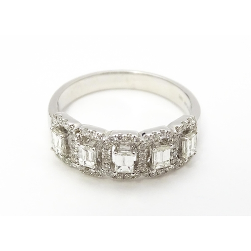 818 - A 14ct white gold ring set with a profusion of diamonds. Ring size approx. T