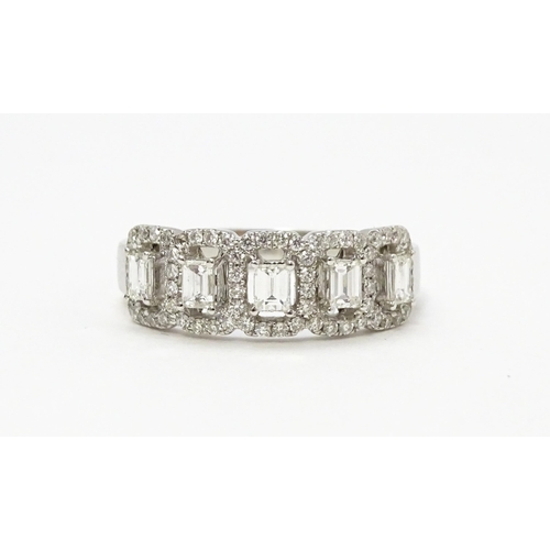 818 - A 14ct white gold ring set with a profusion of diamonds. Ring size approx. T