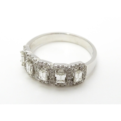 818 - A 14ct white gold ring set with a profusion of diamonds. Ring size approx. T