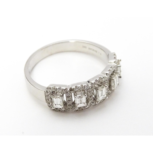 818 - A 14ct white gold ring set with a profusion of diamonds. Ring size approx. T