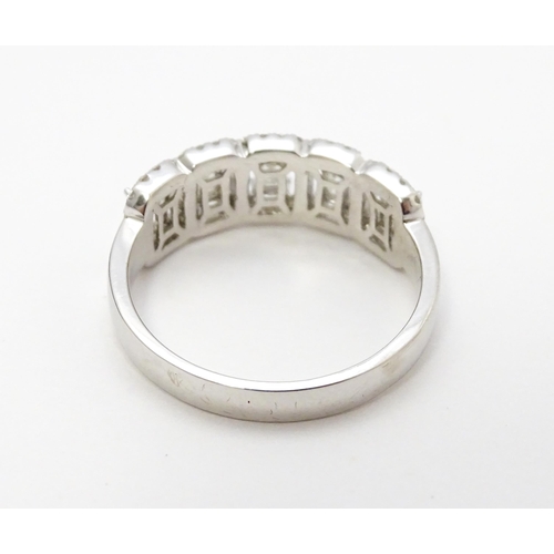 818 - A 14ct white gold ring set with a profusion of diamonds. Ring size approx. T