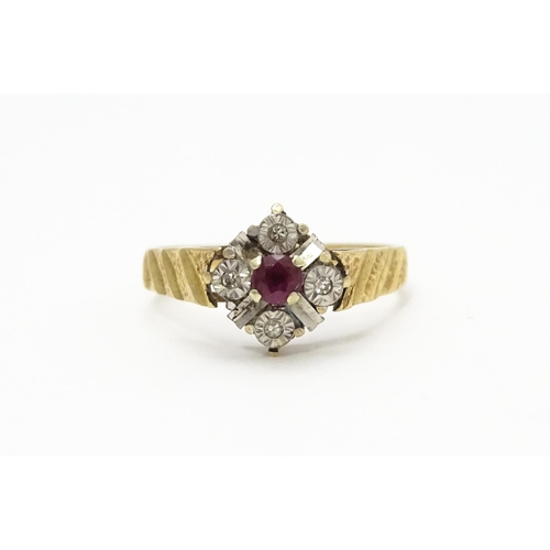 820 - A 9ct gold ring set with central ruby bordered by four diamonds. Ring size approx. M