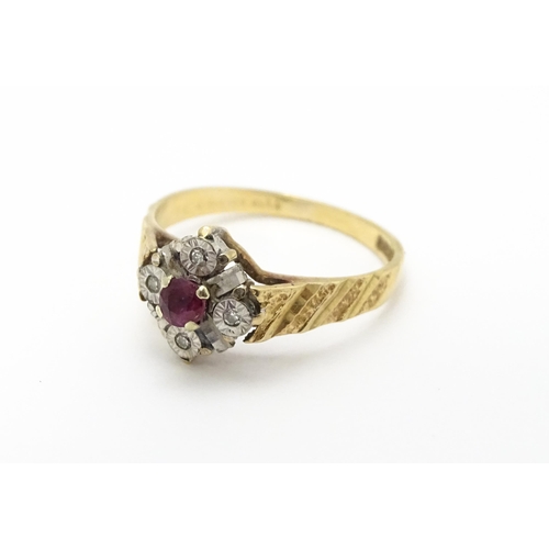 820 - A 9ct gold ring set with central ruby bordered by four diamonds. Ring size approx. M