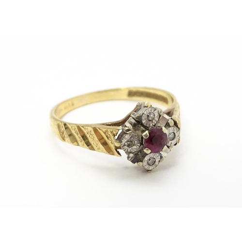 820 - A 9ct gold ring set with central ruby bordered by four diamonds. Ring size approx. M