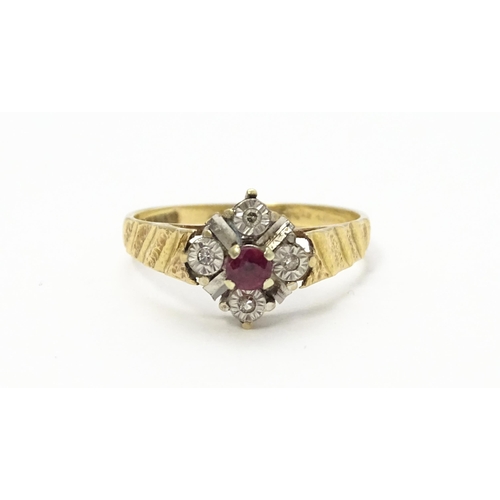 820 - A 9ct gold ring set with central ruby bordered by four diamonds. Ring size approx. M