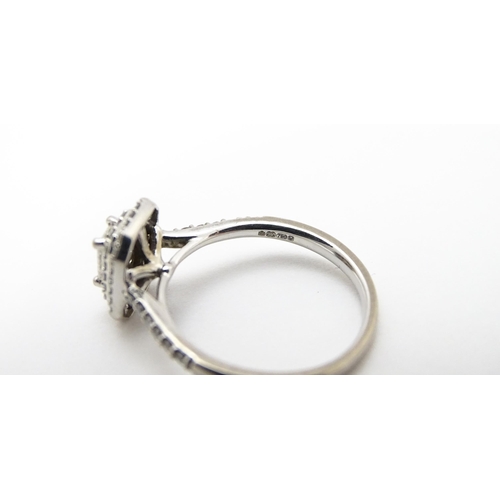 821 - An 18ct white gold ring set with central diamond bordered by two further bands of diamonds and set w... 