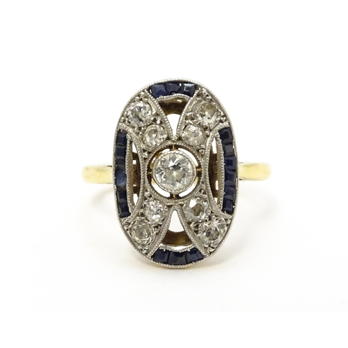 822 - An Art Deco yellow metal ring set with diamonds and sapphires. Ring size approx. J