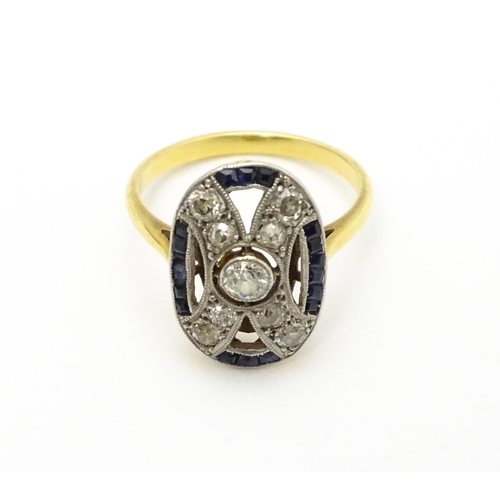 822 - An Art Deco yellow metal ring set with diamonds and sapphires. Ring size approx. J