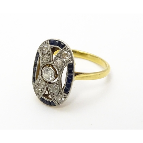 822 - An Art Deco yellow metal ring set with diamonds and sapphires. Ring size approx. J