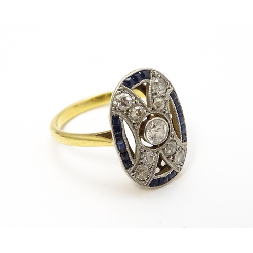 822 - An Art Deco yellow metal ring set with diamonds and sapphires. Ring size approx. J