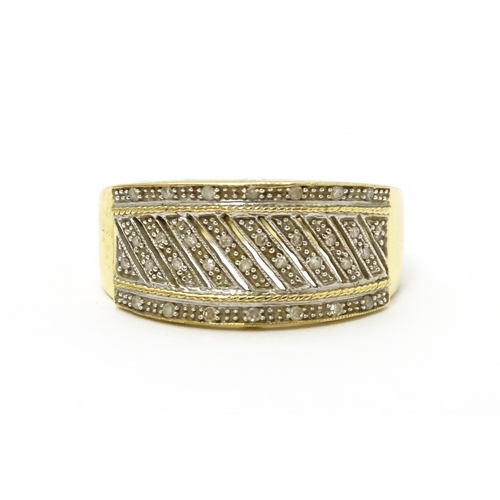 826 - A 9ct gold gentleman's ring set with diamonds. Ring size approx. V