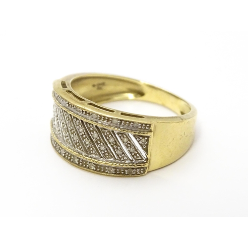 826 - A 9ct gold gentleman's ring set with diamonds. Ring size approx. V