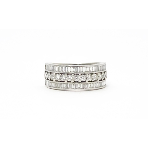 831 - A Hancocks platinum ring set with a profusion of round and baguette cut diamonds. Ring size approx. ... 