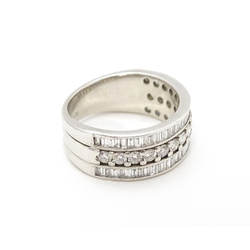 831 - A Hancocks platinum ring set with a profusion of round and baguette cut diamonds. Ring size approx. ... 