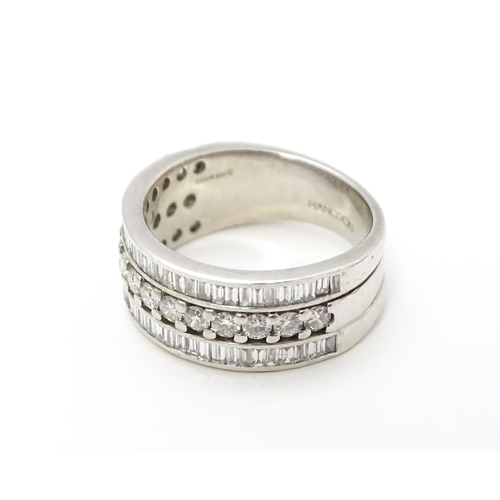 831 - A Hancocks platinum ring set with a profusion of round and baguette cut diamonds. Ring size approx. ... 