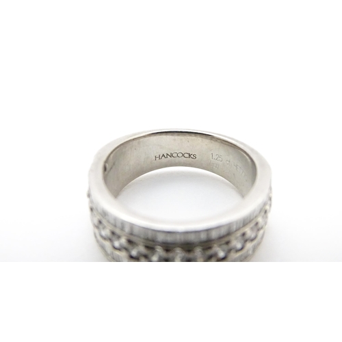 831 - A Hancocks platinum ring set with a profusion of round and baguette cut diamonds. Ring size approx. ... 