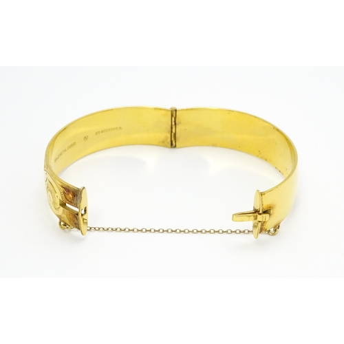 832 - A 9ct gold plated bracelet of bangle form with engraved acanthus scroll detail