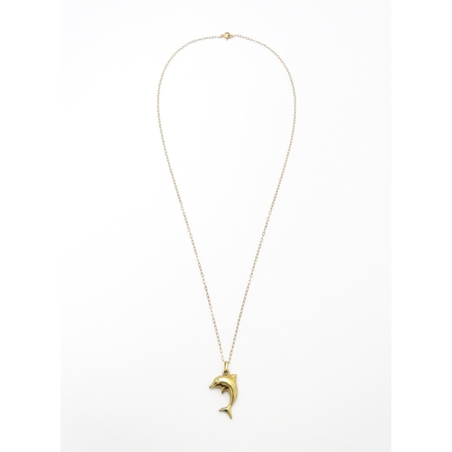 856 - A 9ct gold pendant of dolphin form on a 9ct gold chain. Pendant approx. 1 3/4