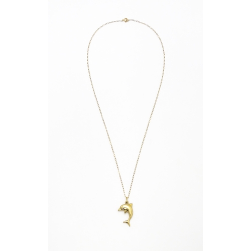 856 - A 9ct gold pendant of dolphin form on a 9ct gold chain. Pendant approx. 1 3/4