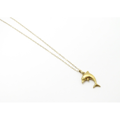 856 - A 9ct gold pendant of dolphin form on a 9ct gold chain. Pendant approx. 1 3/4