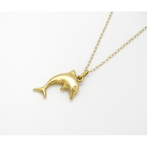 856 - A 9ct gold pendant of dolphin form on a 9ct gold chain. Pendant approx. 1 3/4