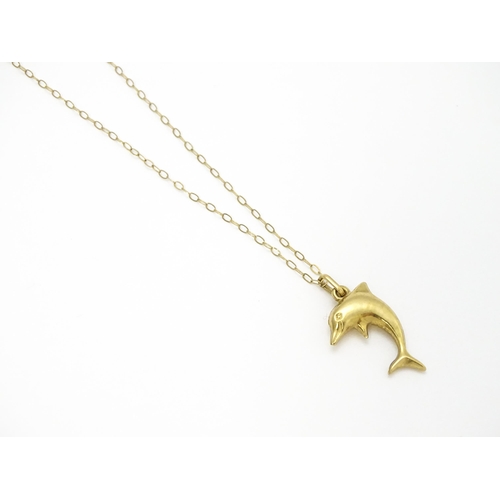 856 - A 9ct gold pendant of dolphin form on a 9ct gold chain. Pendant approx. 1 3/4