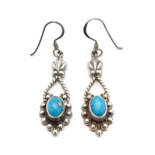 858 - A pair of silver drop earrings set with turquoise coloured cabochon. Approx. 1 1/2