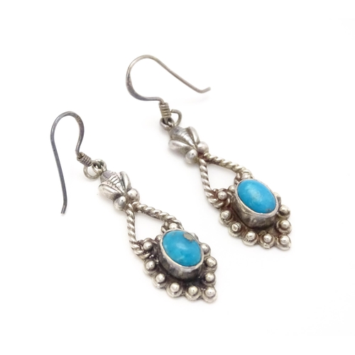 858 - A pair of silver drop earrings set with turquoise coloured cabochon. Approx. 1 1/2