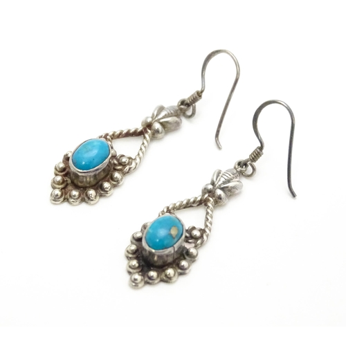 858 - A pair of silver drop earrings set with turquoise coloured cabochon. Approx. 1 1/2