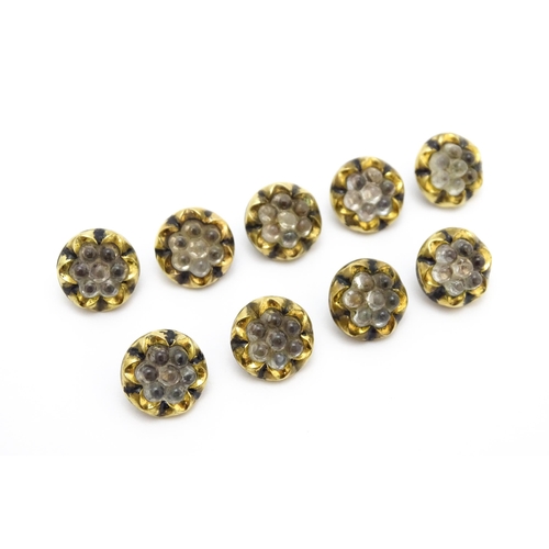 862 - Nine vintage buttons with black enamel and lobed decoration. Approx. 1/2